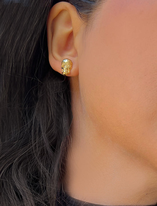 Woman wearing Culturally inclusive Day Of The Dead Mexican Sugar Skull Stud Earrings in 18K Gold over Sterling Silver by Sonia Hou, a celebrity AAPI Chinese demi-fine jewelry designer. This holiday is also known as Dia De Los Muertos, and can also be worn for Halloween!