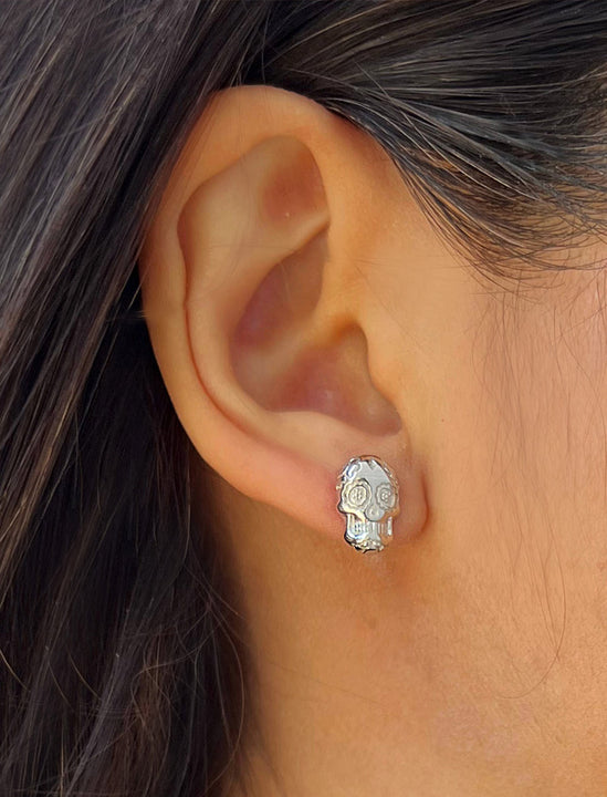 Woman wearing Culturally inclusive Day Of The Dead Mexican Sugar Skull Stud Earrings in Sterling Silver by Sonia Hou, a celebrity AAPI Chinese demi-fine jewelry designer. This holiday is also known as Dia De Los Muertos, and can also be worn for Halloween!