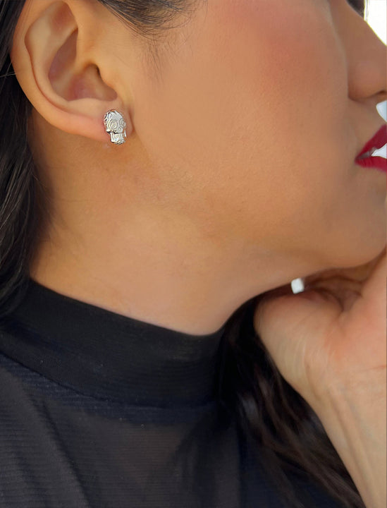 Woman wearing Culturally inclusive Day Of The Dead Mexican Sugar Skull Stud Earrings in Sterling Silver by Sonia Hou, a celebrity AAPI Chinese demi-fine jewelry designer. This holiday is also known as Dia De Los Muertos, and can also be worn for Halloween!