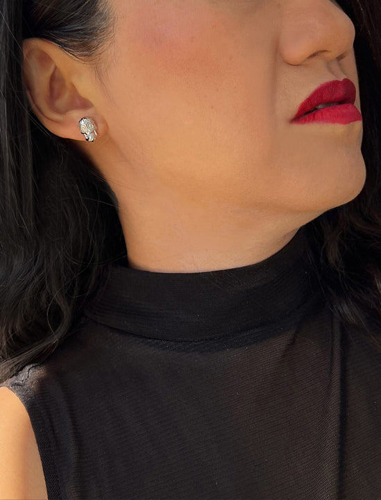 Woman wearing Culturally inclusive Day Of The Dead Mexican Sugar Skull Stud Earrings in Sterling Silver by Sonia Hou, a celebrity AAPI Chinese demi-fine jewelry designer. This holiday is also known as Dia De Los Muertos, and can also be worn for Halloween!