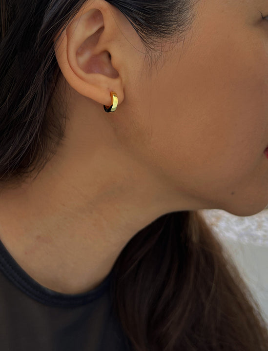 Woman wearing Essential Minimalist 18K Gold Vermeil With 925 Sterling Silver base mini small tiny chunky bold thick dainty stacking layering statement round hoop huggie earrings by Sonia Hou, a celebrity AAPI Chinese demi-fine jewelry designer