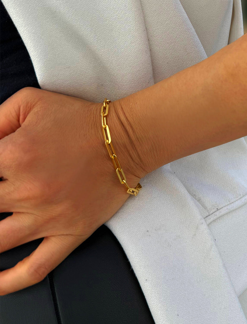 18K gold vermeil (sterling silver base) chain bracelet on a person's wrist.  Our medium Essential paperclip link chain bracelet is perfect for everyday wear. Designed by AAPI celebrity jewelry designer SONIA HOU.