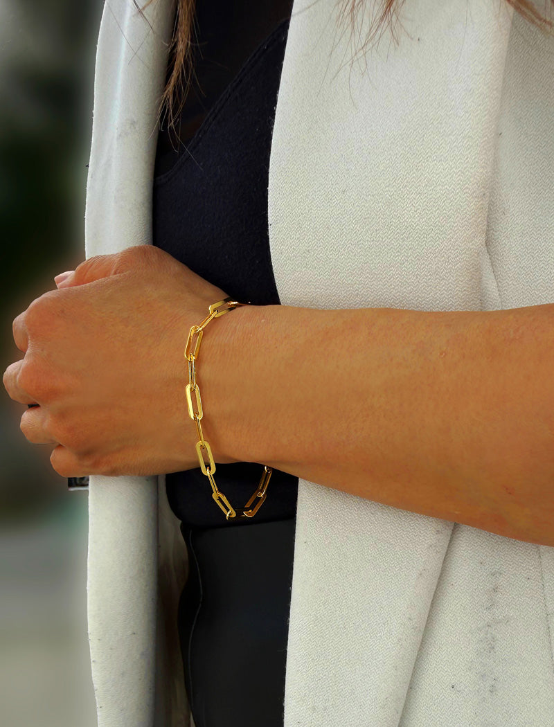 18K gold vermeil (sterling silver base) chain bracelet on a person's wrist.  Our medium Essential paperclip link chain bracelet is perfect for everyday wear. Designed by AAPI celebrity jewelry designer SONIA HOU.