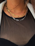 Sterling silver chain necklace on a person's neck.  Our medium Essential paperclip link chain necklace is perfect for everyday wear. Designed by AAPI celebrity jewelry designer SONIA HOU.