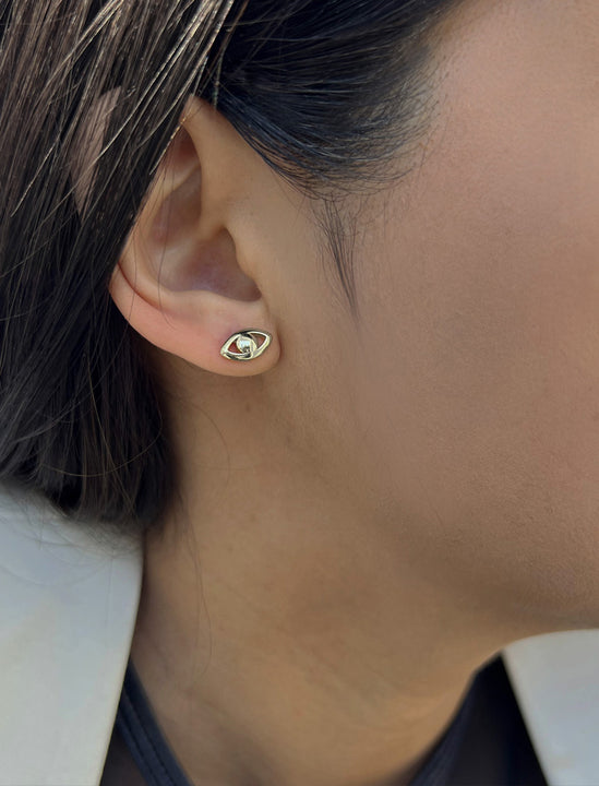 Female model wearing tiny dainty small minimalist inclusive Evil Eye Stud Earrings, inspired by Greek culture, in 925 Sterling Silver by Sonia Hou, a celebrity Asian AAPI Chinese demi-fine fashion costume jewelry designer