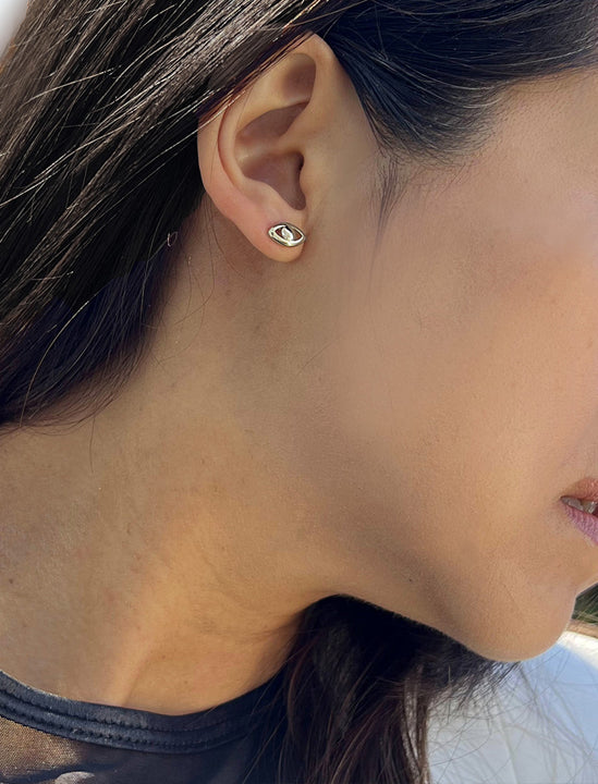 Female model wearing tiny dainty small minimalist inclusive Evil Eye Stud Earrings, inspired by Greek culture, in 925 Sterling Silver by Sonia Hou, a celebrity Asian AAPI Chinese demi-fine fashion costume jewelry designer