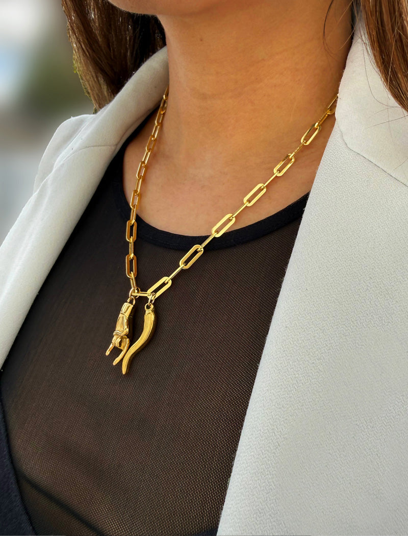 Person wearing an Italian Hand & Horn pendant—also known as Mano Cornuta or the “Horned Hand” amulet in 18K Gold Vermeil (sterling Silver base).  Designed for everyone who values inclusivity, diversity, and meaning, it’s a timeless statement of strength and modern style. It's perfect for everyday wear. Designed by AAPI celebrity jewelry designer SONIA HOU.