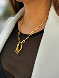 Person wearing an Italian Hand & Horn pendant—also known as Mano Cornuta or the “Horned Hand” amulet in 18K Gold Vermeil (sterling Silver base).  Designed for everyone who values inclusivity, diversity, and meaning, it’s a timeless statement of strength and modern style. It's perfect for everyday wear. Designed by AAPI celebrity jewelry designer SONIA HOU.