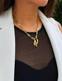 Person wearing an Italian Hand & Horn pendant—also known as Mano Cornuta or the “Horned Hand” amulet in 18K Gold Vermeil (sterling Silver base).  Designed for everyone who values inclusivity, diversity, and meaning, it’s a timeless statement of strength and modern style. It's perfect for everyday wear. Designed by AAPI celebrity jewelry designer SONIA HOU.