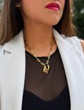 Person wearing a waterproof Italian Hand pendant necklace—also known as Mano Cornuta or the “Horned Hand” amulet and Italian Horn  in 18K Gold PVD stainless steel.  Designed for everyone who values inclusivity, diversity, and meaning, it’s a timeless statement of strength and modern style. It's perfect for everyday wear. Designed by AAPI celebrity jewelry designer SONIA HOU.