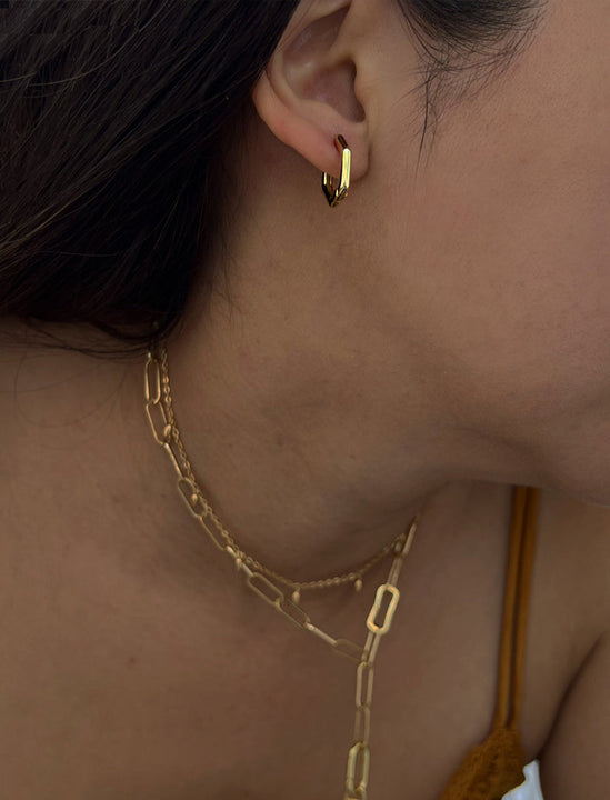 Female model wearing minimalist mini tiny small chunky bold thick dainty stacking layering statement round INNOVATE Hexagon Huggie Hoop Earrings in 18K Gold Vermeil With 925 Sterling Silver base by Sonia Hou, a celebrity AAPI Chinese demi-fine jewelry designer