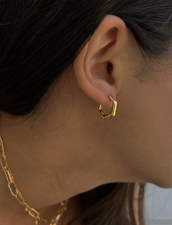 Female model wearing minimalist mini tiny small chunky bold thick dainty stacking layering statement round INNOVATE Hexagon Huggie Hoop Earrings in 18K Gold Vermeil With 925 Sterling Silver base by Sonia Hou, a celebrity AAPI Chinese demi-fine jewelry designer