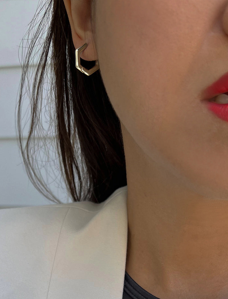 Woman wearing Minimalist mini tiny small chunky bold thick dainty stacking layering statement round INNOVATE Hexagon Huggie Hoop Earrings in 925 Sterling Silver by Sonia Hou, a celebrity Asian AAPI Chinese demi-fine jewelry designer
