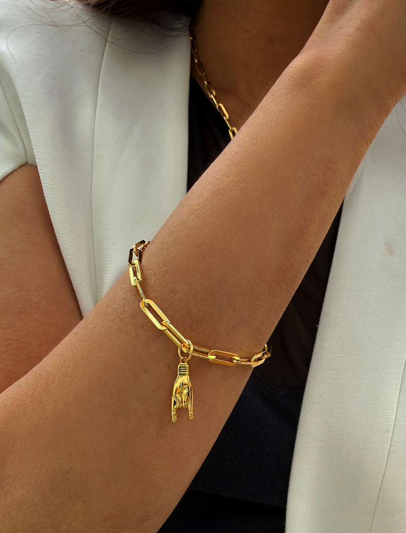 18K gold vermeil (sterling silver base) chain bracelet with a hand charm on a wrist. Rooted in ancient Italian tradition, the Italian Hand — also known as Mano Cornuta or the “Horned Hand” — has long been worn as a protective amulet to ward off the Evil Eye and negative energy. Symbolizes strength, defense, and good fortune. Designed by AAPI celebrity jewelry designer SONIA HOU.

