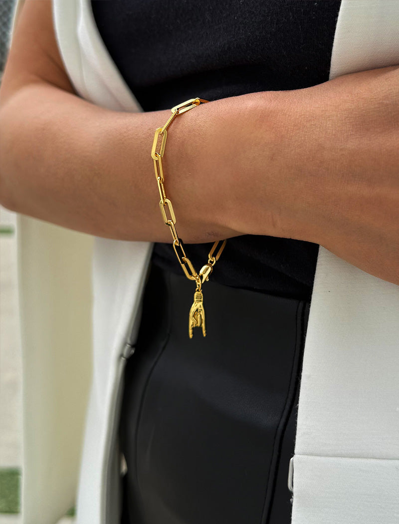 18K gold vermeil (sterling silver base) chain bracelet with a hand charm on a wrist. Rooted in ancient Italian tradition, the Italian Hand — also known as Mano Cornuta or the “Horned Hand” — has long been worn as a protective amulet to ward off the Evil Eye and negative energy. Symbolizes strength, defense, and good fortune. Designed by AAPI celebrity jewelry designer SONIA HOU.
