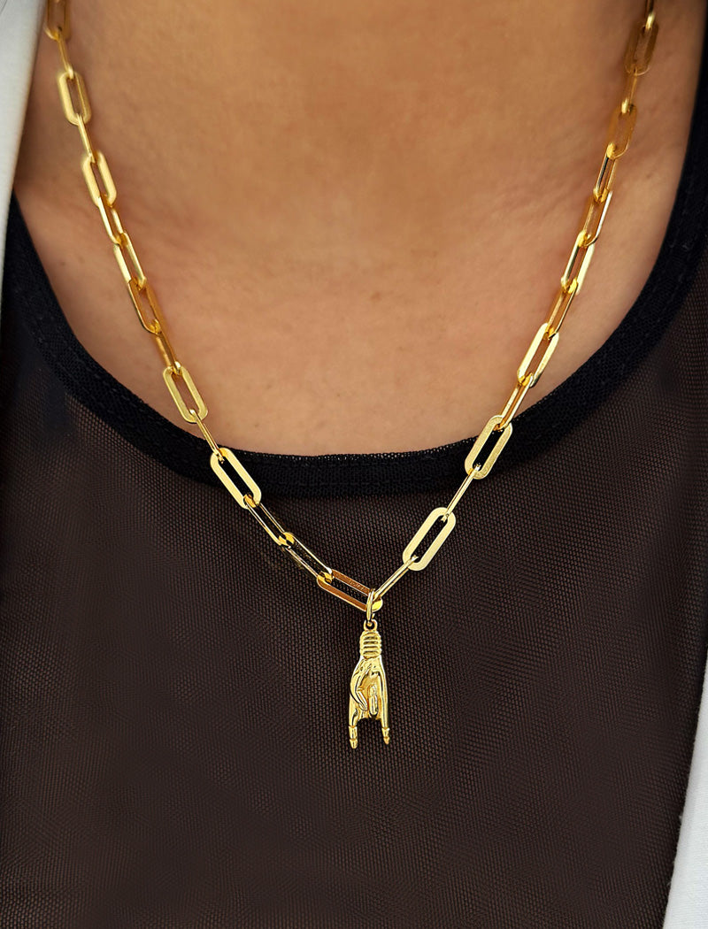 Person wearing an Italian Hand pendant—also known as Mano Cornuta or the “Horned Hand” amulet in 18K Gold Vermeil (sterling Silver base).  Designed for everyone who values inclusivity, diversity, and meaning, it’s a timeless statement of strength and modern style. It's perfect for everyday wear. Designed by AAPI celebrity jewelry designer SONIA HOU.