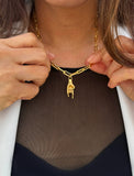 Person wearing an Italian Hand pendant—also known as Mano Cornuta or the “Horned Hand” amulet in 18K Gold Vermeil (sterling Silver base).  Designed for everyone who values inclusivity, diversity, and meaning, it’s a timeless statement of strength and modern style. It's perfect for everyday wear. Designed by AAPI celebrity jewelry designer SONIA HOU.