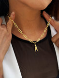 Person wearing an Italian Hand pendant—also known as Mano Cornuta or the “Horned Hand” amulet in 18K Gold Vermeil (sterling Silver base).  Designed for everyone who values inclusivity, diversity, and meaning, it’s a timeless statement of strength and modern style. It's perfect for everyday wear. Designed by AAPI celebrity jewelry designer SONIA HOU.