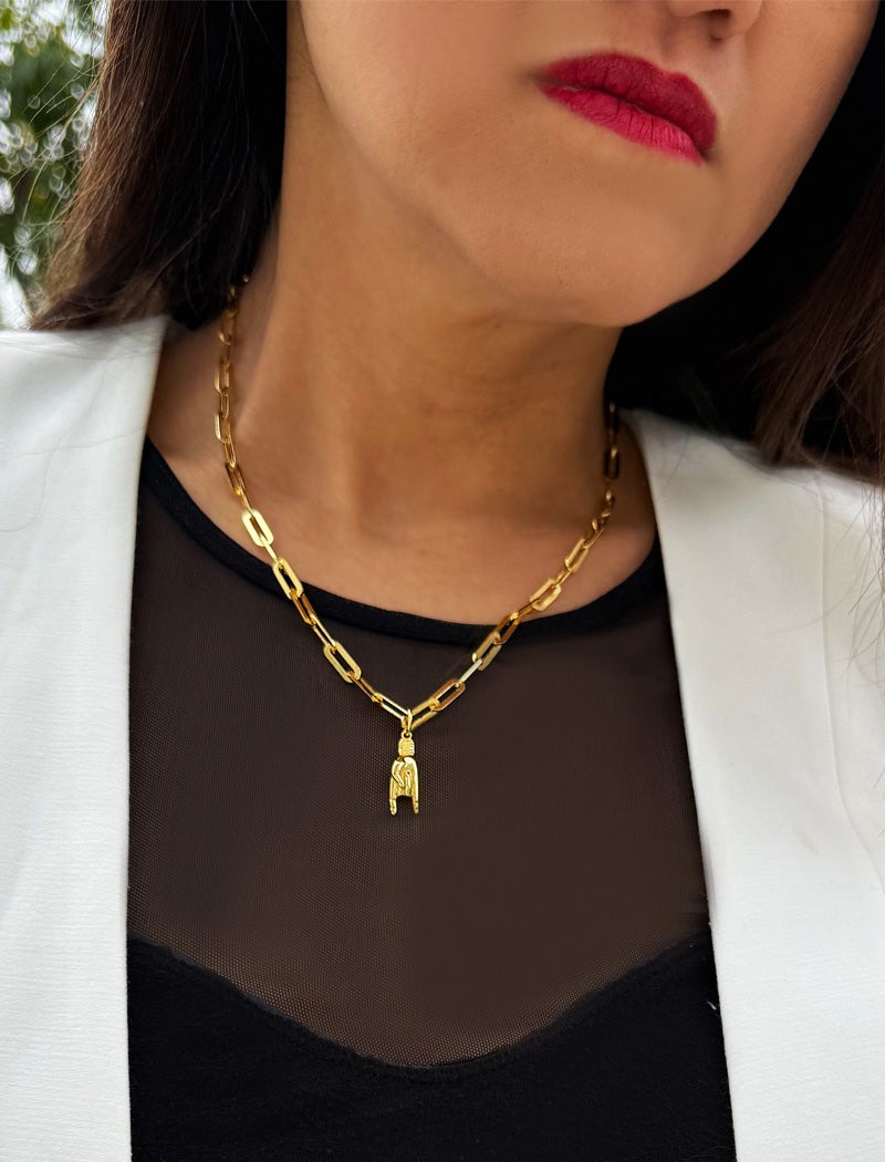 Person wearing an Italian Hand pendant—also known as Mano Cornuta or the “Horned Hand” amulet in 18K Gold Vermeil (sterling Silver base).  Designed for everyone who values inclusivity, diversity, and meaning, it’s a timeless statement of strength and modern style. It's perfect for everyday wear. Designed by AAPI celebrity jewelry designer SONIA HOU.