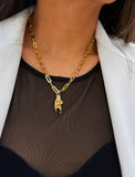 Person wearing a waterproof Italian Hand pendant necklace—also known as Mano Cornuta or the “Horned Hand” amulet in 18K Gold PVD stainless steel.  Designed for everyone who values inclusivity, diversity, and meaning, it’s a timeless statement of strength and modern style. It's perfect for everyday wear. Designed by AAPI celebrity jewelry designer SONIA HOU.