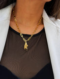 Person wearing an Italian Hand pendant—also known as Mano Cornuta or the “Horned Hand” amulet in 18K Gold Vermeil (sterling Silver base).  Designed for everyone who values inclusivity, diversity, and meaning, it’s a timeless statement of strength and modern style. It's perfect for everyday wear. Designed by AAPI celebrity jewelry designer SONIA HOU.