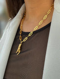 Person wearing a waterproof Italian Hand pendant necklace—also known as Mano Cornuta or the “Horned Hand” amulet in 18K Gold PVD stainless steel.  Designed for everyone who values inclusivity, diversity, and meaning, it’s a timeless statement of strength and modern style. It's perfect for everyday wear. Designed by AAPI celebrity jewelry designer SONIA HOU.