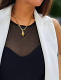 Person wearing a waterproof Italian Hand pendant necklace—also known as Mano Cornuta or the “Horned Hand” amulet in 18K Gold PVD stainless steel.  Designed for everyone who values inclusivity, diversity, and meaning, it’s a timeless statement of strength and modern style. It's perfect for everyday wear. Designed by AAPI celebrity jewelry designer SONIA HOU.
