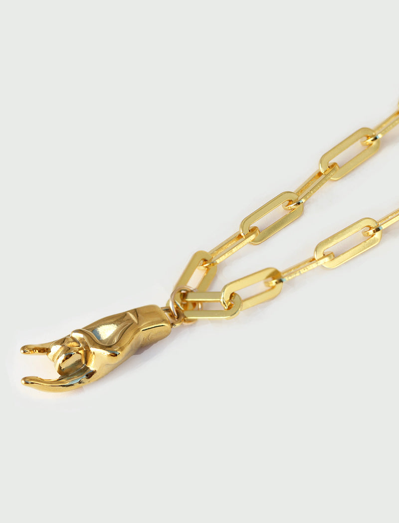 18K Gold PVD Stainless steel waterproof chain bracelet with a charm worn by a person in a brown shirt. Rooted in ancient Italian tradition, the Italian Hand — also known as Mano Cornuta or the “Horned Hand” — has long been worn as a protective amulet to ward off the Evil Eye and negative energy. Symbolizes strength, defense, and good fortune. Designed by AAPI celebrity jewelry designer SONIA HOU.

