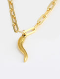 Inspired by centuries-old Italian tradition, this photo showcases a person wearing a modern chain pendant necklace with the Italian Horn —also known as the cornicello—a powerful emblem of protection, strength, and good fortune. Made of 18K Gold Vermeil (sterling Silver base).  Designed for everyone who values inclusivity, diversity, and meaning, it’s a timeless statement of strength and modern style. It's perfect for everyday wear. Designed by AAPI celebrity jewelry designer SONIA HOU.