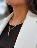 Inspired by centuries-old Italian tradition, this photo showcases a person wearing a modern chain pendant necklace with the Italian Horn —also known as the cornicello— a powerful emblem of protection, strength, and good fortune. Made of 18K Gold Vermeil (sterling silver).  Designed for everyone who values inclusivity, diversity, and meaning, it’s a timeless statement of strength and modern style. It's perfect for everyday wear. Designed by AAPI celebrity jewelry designer SONIA HOU.