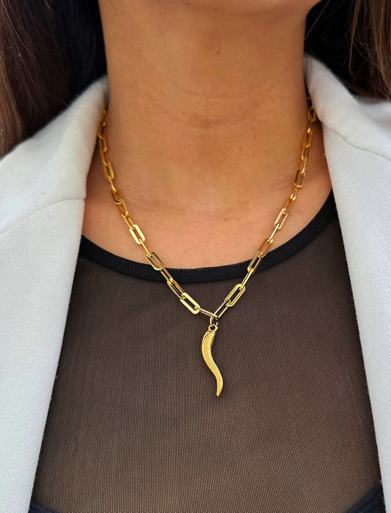 Inspired by centuries-old Italian tradition, this photo showcases a person wearing a modern chain pendant necklace with the Italian Horn —also known as the cornicello—a powerful emblem of protection, strength, and good fortune. Made of 18K Gold PVD Stainless Steel (waterproof)..  Designed for everyone who values inclusivity, diversity, and meaning, it’s a timeless statement of strength and modern style. It's perfect for everyday wear. Designed by AAPI celebrity jewelry designer SONIA HOU.