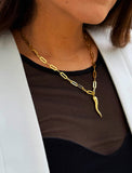 Inspired by centuries-old Italian tradition, this photo showcases a person wearing a modern chain pendant necklace with the Italian Horn —also known as the cornicello—a powerful emblem of protection, strength, and good fortune. Made of 18K Gold Vermeil (sterling Silver base).  Designed for everyone who values inclusivity, diversity, and meaning, it’s a timeless statement of strength and modern style. It's perfect for everyday wear. Designed by AAPI celebrity jewelry designer SONIA HOU.