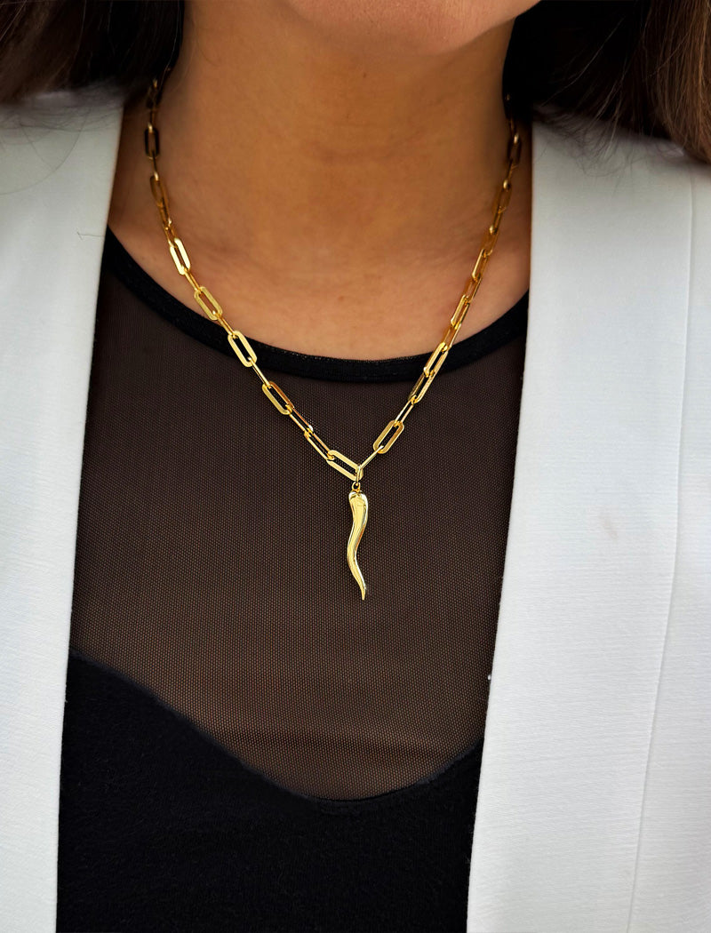 Inspired by centuries-old Italian tradition, this photo showcases a person wearing a modern chain pendant necklace with the Italian Horn —also known as the cornicello—a powerful emblem of protection, strength, and good fortune. Made of 18K Gold Vermeil (sterling Silver base).  Designed for everyone who values inclusivity, diversity, and meaning, it’s a timeless statement of strength and modern style. It's perfect for everyday wear. Designed by AAPI celebrity jewelry designer SONIA HOU.