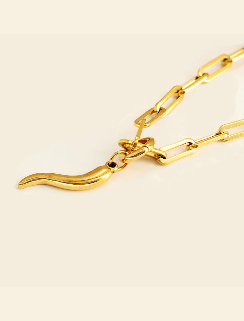 Inspired by centuries-old Italian tradition, this photo showcases a person wearing a modern chain pendant necklace with the Italian Horn —also known as the cornicello—a powerful emblem of protection, strength, and good fortune. Made of 18K Gold PVD Stainless Steel (waterproof).  Designed for everyone who values inclusivity, diversity, and meaning, it’s a timeless statement of strength and modern style. It's perfect for everyday wear. Designed by AAPI celebrity jewelry designer SONIA HOU.
