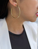 Female model wearing big medium large thin round circle PERFECT 50mm or 2 inch hoop stacking lightweight everyday statement earrings in 18K Gold Vermeil With 925 Sterling Silver base by Sonia Hou, a celebrity AAPI Chinese demi-fine jewelry designer
