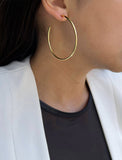 Female model wearing big medium large thin round circle PERFECT 50mm 2 inch hoop stacking lightweight everyday statement earrings in 18K Gold Vermeil With 925 Sterling Silver base by Sonia Hou, a celebrity AAPI Chinese demi-fine jewelry designer