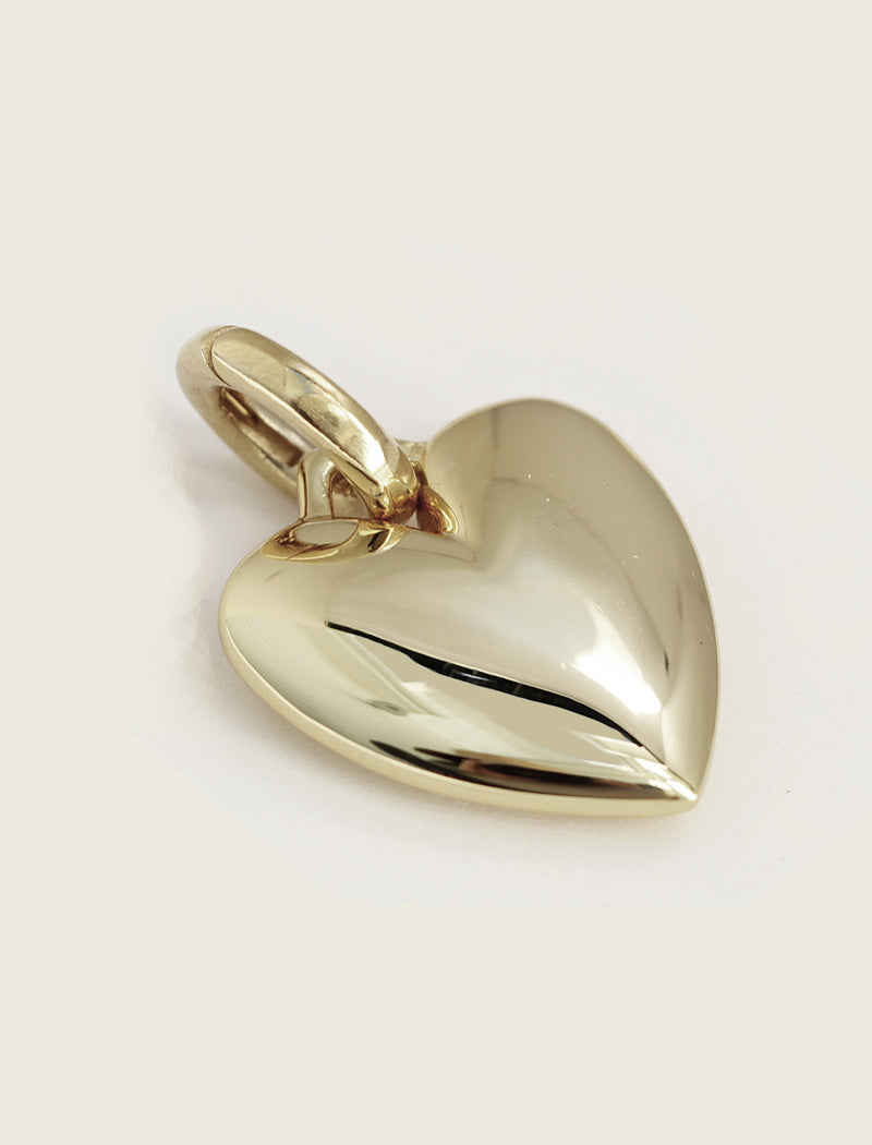 Gold heart-shaped pendant on a light gray background