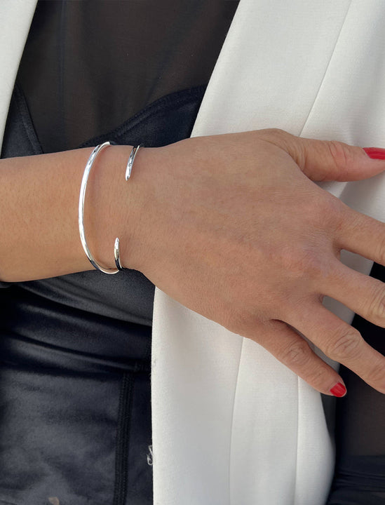 Female model wearing adjustable minimalist simple Success Thin Cuff Chunky Bold Layering Stacking Statement 2 Way convertible Bangle Cuff Open Bracelet in 925 sterling silver by Sonia Hou, a celebrity AAPI Chinese demi-fine fashion costume jewelry designer