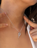 A close-up of a person's neck and chest wearing a delicate silver chain necklace with a tennis ball racket-shaped pendant. Designed by Sonia Hou, a celebrity AAPI inclusive demi-fine jewelry designer. Available in 18K Gold Over Sterling Silver, Sterling Silver and 18K Gold PVD Sterling Silver (Waterproof).