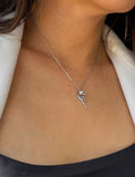 A close-up of a model wearing a delicate silver chain necklace with a small tennis ball racquet. Designed by Sonia Hou, a celebrity AAPI inclusive demi-fine jewelry designer. Available in 18K Gold Over Sterling Silver, Sterling Silver and 18K Gold PVD Sterling Silver (Waterproof).