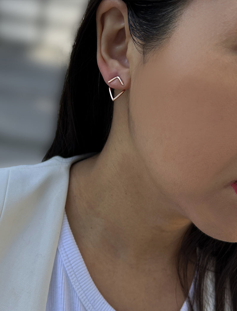 Female model wearing small modern geometric minimalist simple 2-way convertible TRILL dainty wishbone diamond front back ear jacket stud earrings in 18K rose gold vermeil with 925 sterling silver base by Sonia Hou, a celebrity AAPI Chinese demi-fine fashion costume jewelry designer