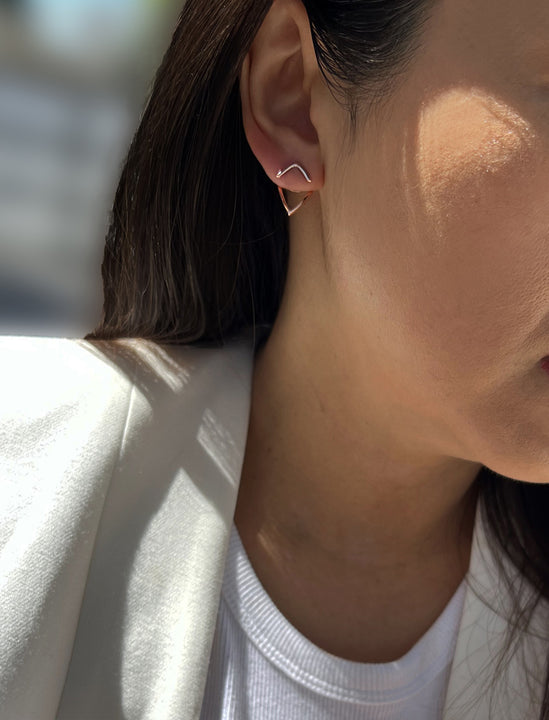 Female model wearing small modern geometric minimalist simple 2-way convertible TRILL dainty wishbone diamond front back ear jacket stud earrings in 18K rose gold vermeil with 925 sterling silver base by Sonia Hou, a celebrity AAPI Chinese demi-fine fashion costume jewelry designer