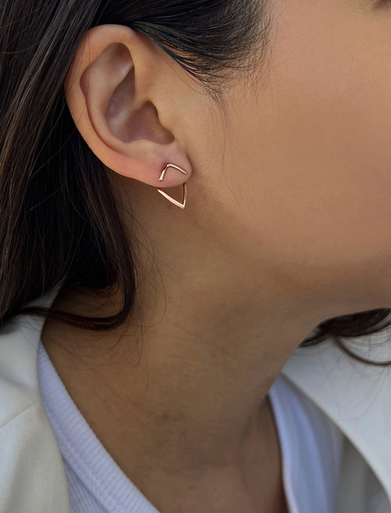 Female model wearing small modern geometric minimalist simple 2-way convertible TRILL dainty wishbone diamond front back ear jacket stud earrings in 18K rose gold vermeil with 925 sterling silver base by Sonia Hou, a celebrity AAPI Chinese demi-fine fashion costume jewelry designer