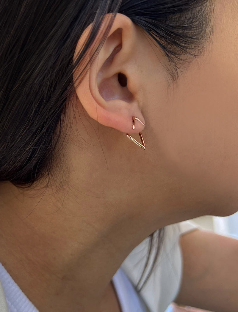Female model wearing small modern geometric minimalist simple 2-way convertible TRILL dainty wishbone diamond front back ear jacket stud earrings in 18K rose gold vermeil with 925 sterling silver base by Sonia Hou, a celebrity AAPI Chinese demi-fine fashion costume jewelry designer