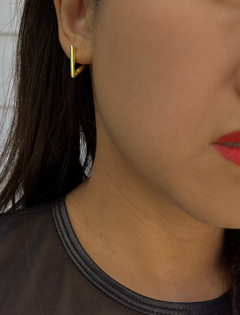 Female model wearing ACHIEVE TRIANGLE GEOMETRIC HUGGIE EARRINGS IN 18K GOLD VERMEIL With Sterling Silver base by Sonia Hou Jewelry