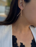 Female model wearing Asian Inspired Chopsticks Minimalist Long Thin Dangle Earrings in 18K Rose Gold Vermeil With Sterling Silver base by Sonia Hou, a celebrity AAPI demi-fine jewelry designer