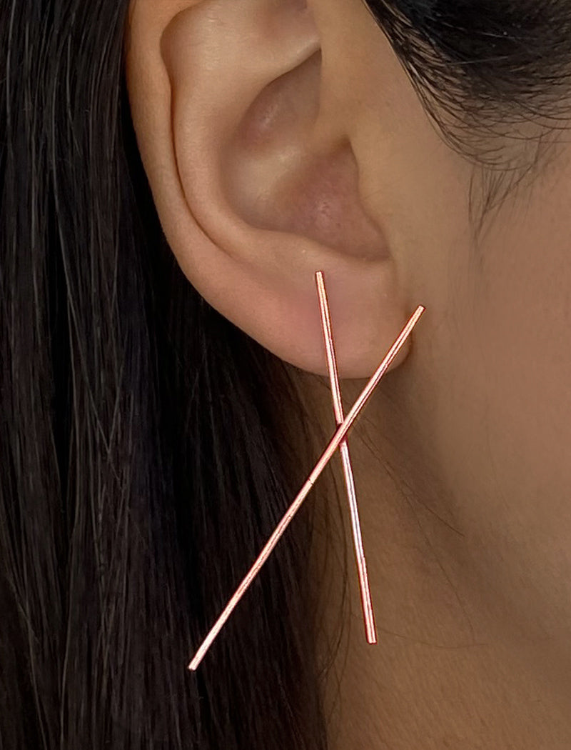 Female model wearing Asian Inspired Chopsticks Minimalist Long Thin Dangle Earrings in 18K Rose Gold Vermeil With Sterling Silver base by Sonia Hou, a celebrity AAPI demi-fine jewelry designer