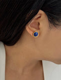 Female model wearing luxe minimalist small or big FIRE 3-Way Convertible Blue Denim Lapis Lazuli Gemstone Round Stud earrings in 24K Gold by Sonia Hou, a celebrity AAPI Asian Chinese demi-fine fashion costume jewelry designer. 