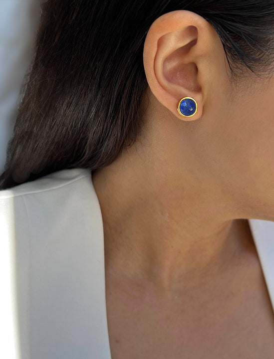 Female model wearing luxe minimalist small or big FIRE 3-Way Convertible Blue Denim Lapis Lazuli Gemstone Round Stud earrings in 24K Gold by Sonia Hou, a celebrity AAPI Asian Chinese demi-fine fashion costume jewelry designer. 