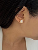 Female model wearing luxe minimalist small or big FIRE 3-Way Convertible White Quartz Gemstone Round Stud earrings in 24K Gold by Sonia Hou, a celebrity AAPI Asian Chinese demi-fine fashion costume jewelry designer. 